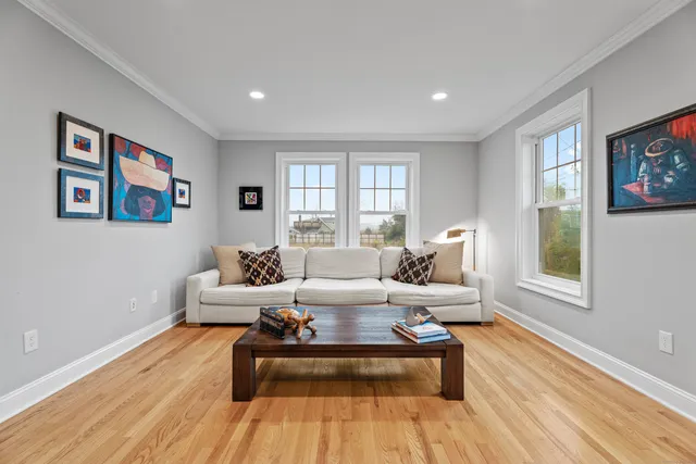 a living room with furniture two windows and a rug
