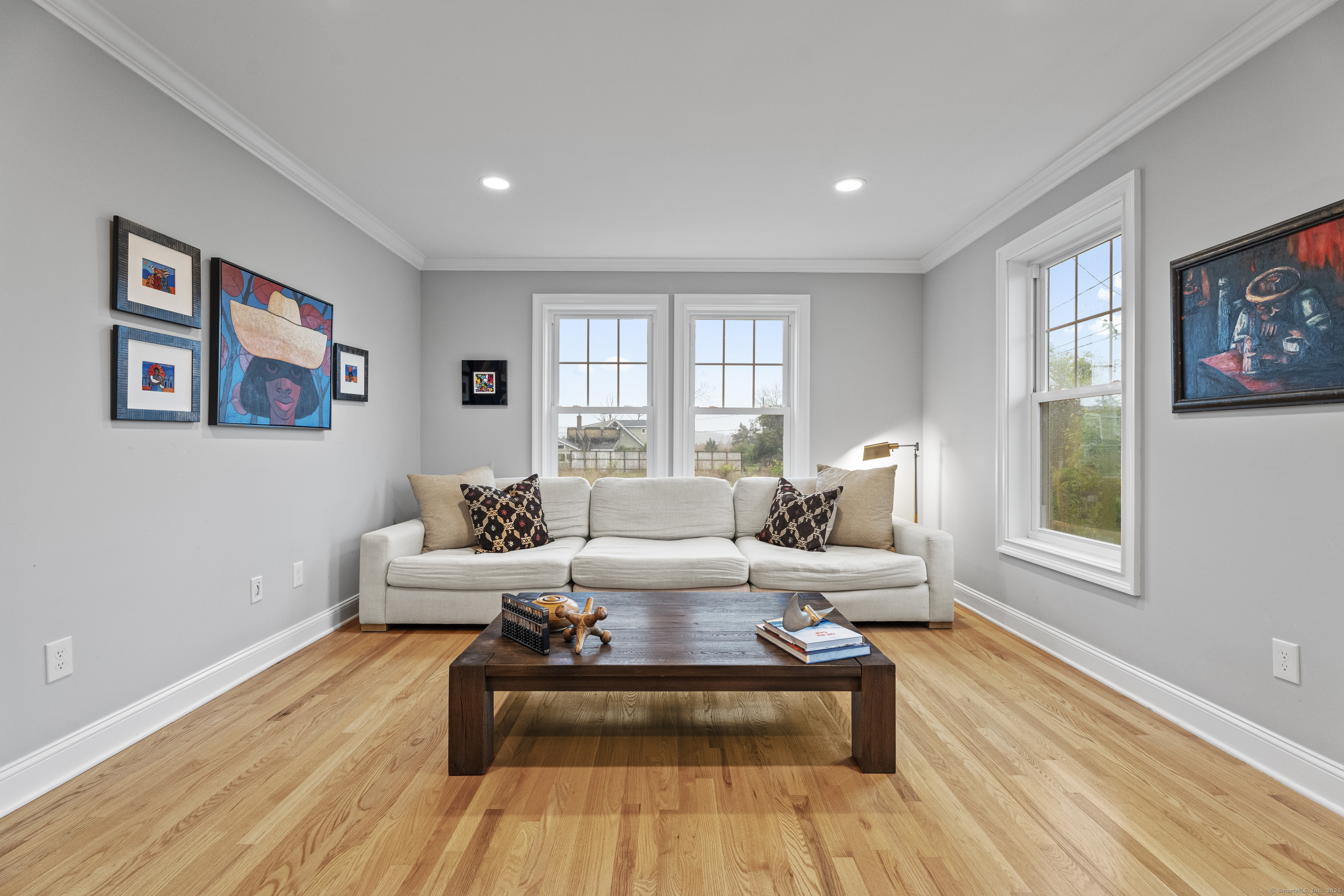3 Arrowhead Road Madison, CT 06443 - Photo 19 of 40 a living room with furniture two windows and a rug