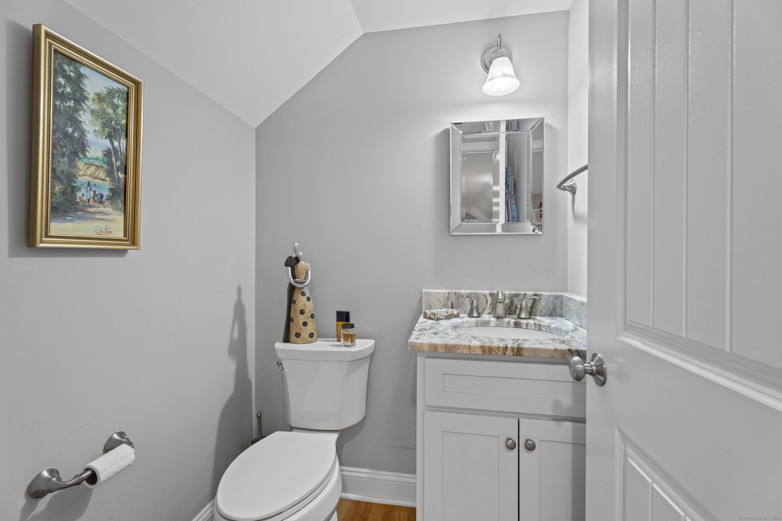 3 Arrowhead Road Madison, CT 06443 - Photo 22 of 40 a bathroom with a toilet sink and mirror