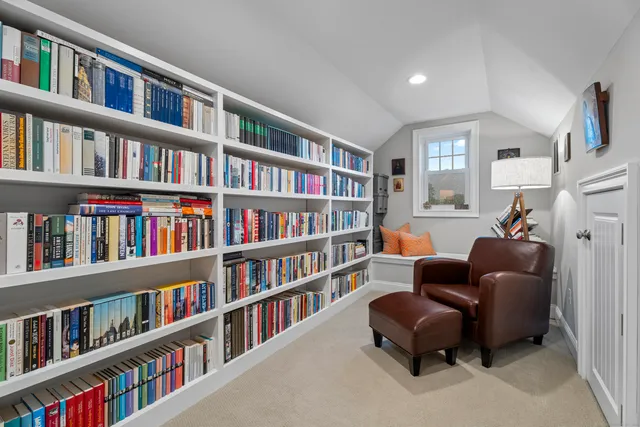 a living room with lots of books