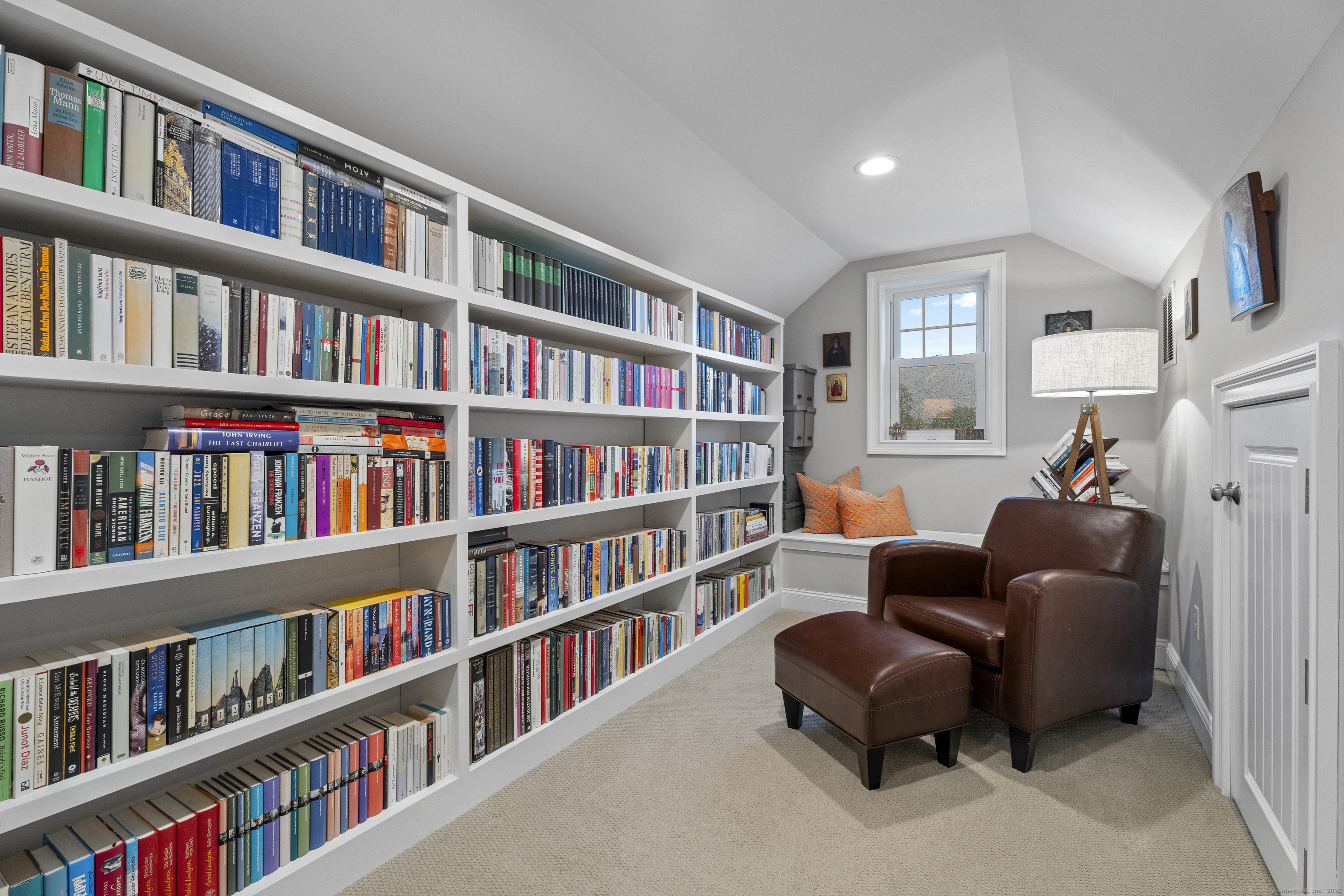 3 Arrowhead Road Madison, CT 06443 - Photo 23 of 40 a living room with lots of books