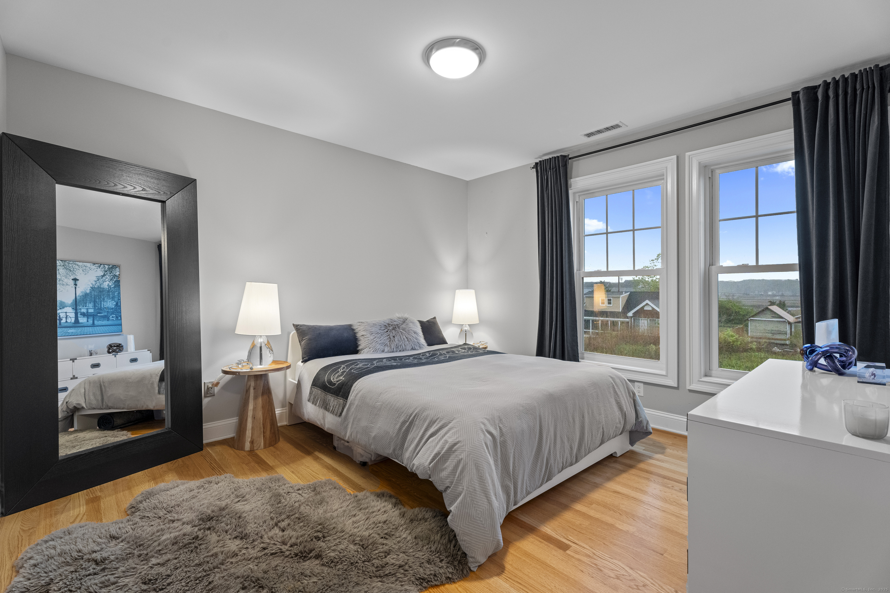 3 Arrowhead Road Madison, CT 06443 - Photo 24 of 40 a bedroom with a bed and large windows