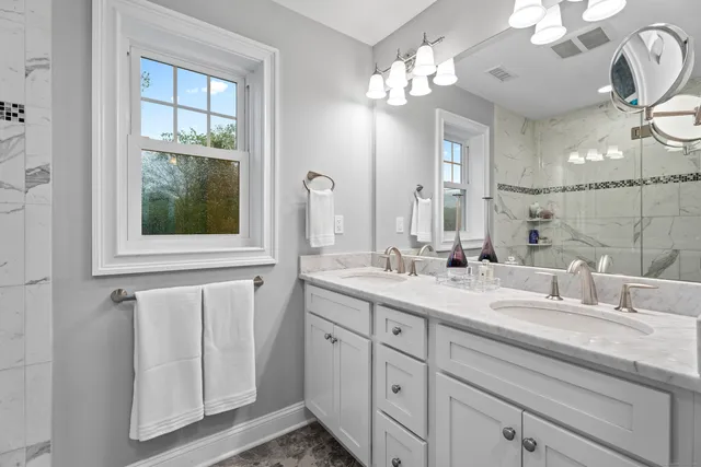 a bathroom with a double vanity sink and a mirror