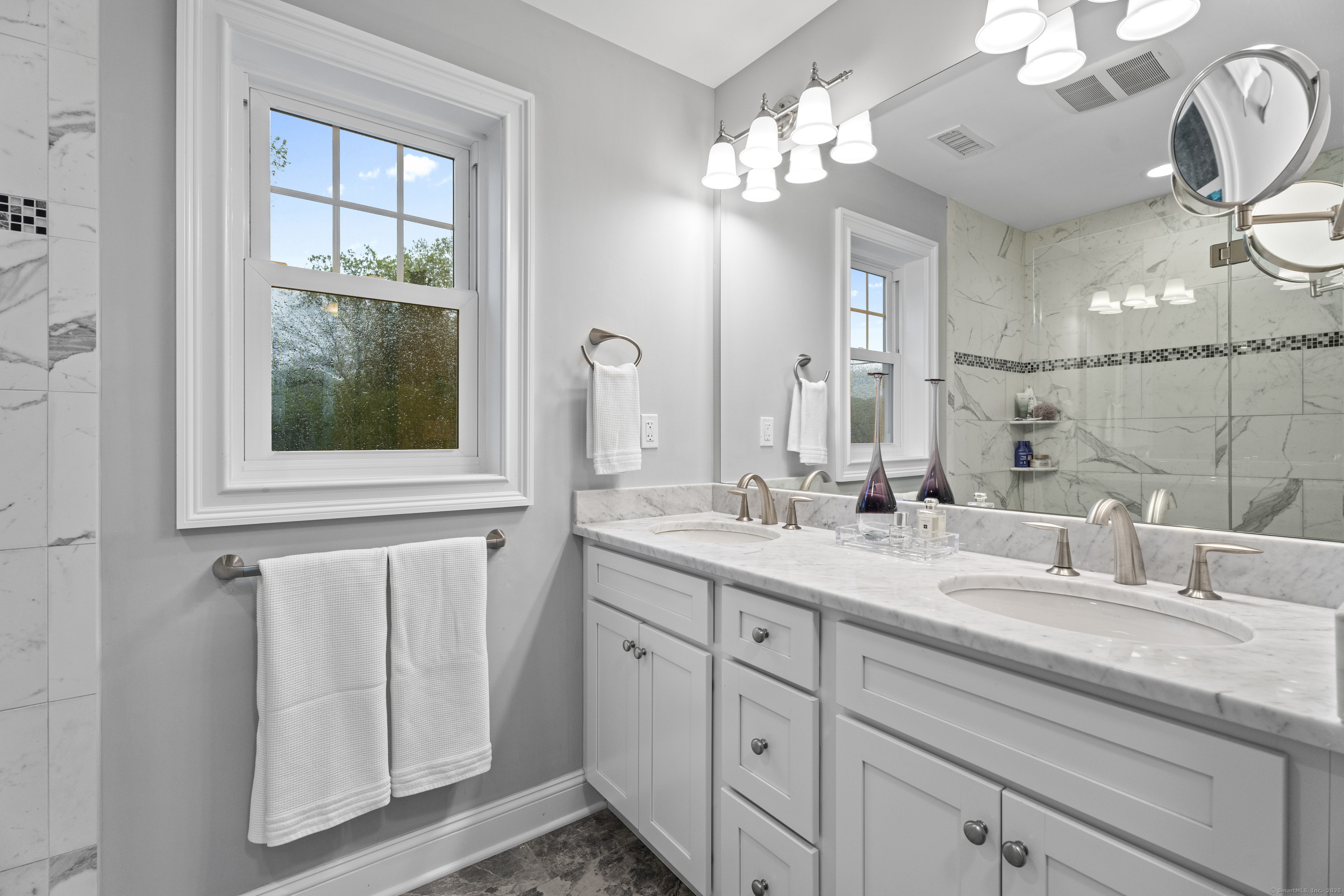 3 Arrowhead Road Madison, CT 06443 - Photo 29 of 40 a bathroom with a double vanity sink and a mirror