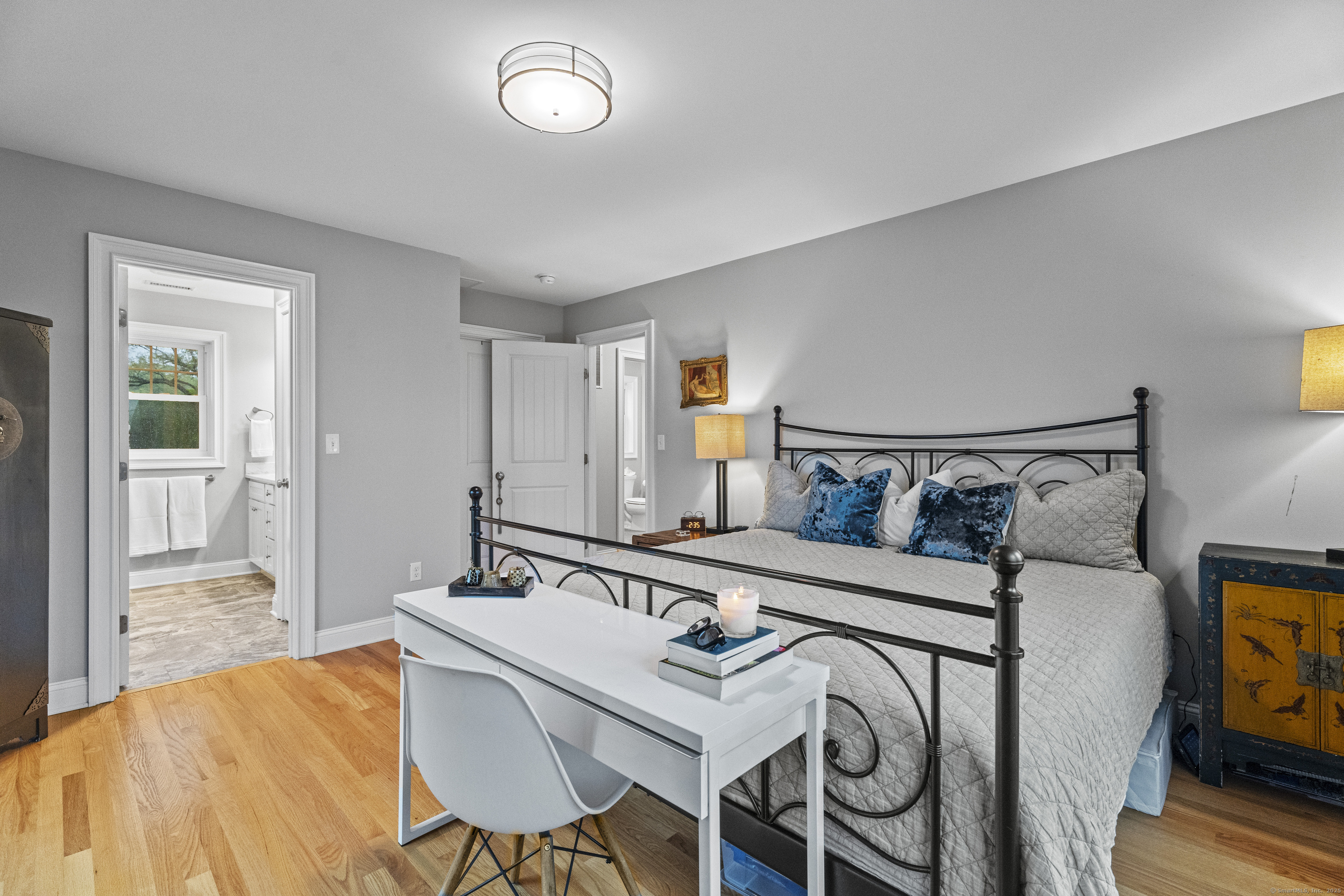 3 Arrowhead Road Madison, CT 06443 - Photo 32 of 40 a bedroom with a bed and a table in it