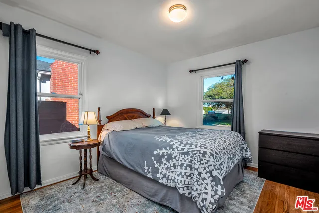 a bathroom with a granite countertop toilet sink and mirror