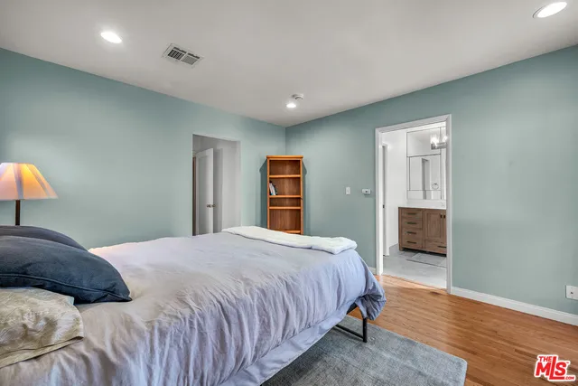 a spacious bedroom with a bed and furniture