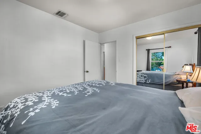 a view of a room with wooden floor and windows