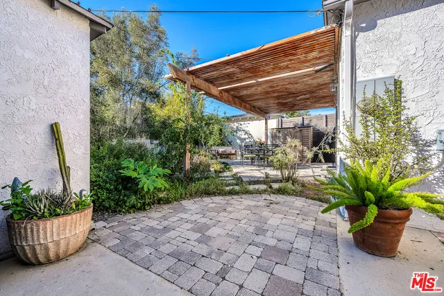 a view of an outdoor dining space with a patio