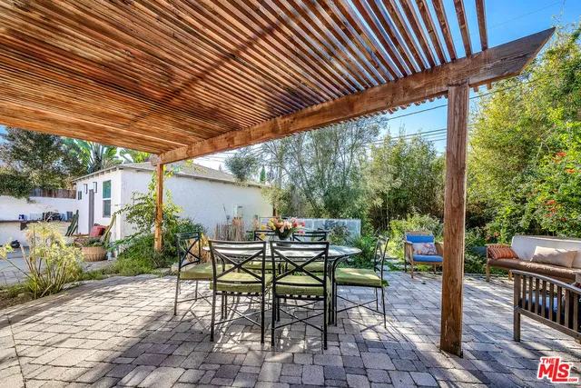 a view of a patio with table and chairs and potted plants