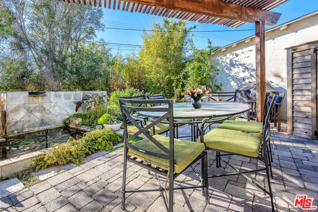 a view of a chairs and table in the backyard