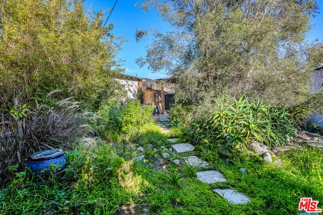 an outdoor space with patio and white umbrellas