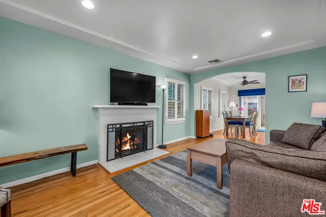 a living room with furniture a fireplace and a flat screen tv