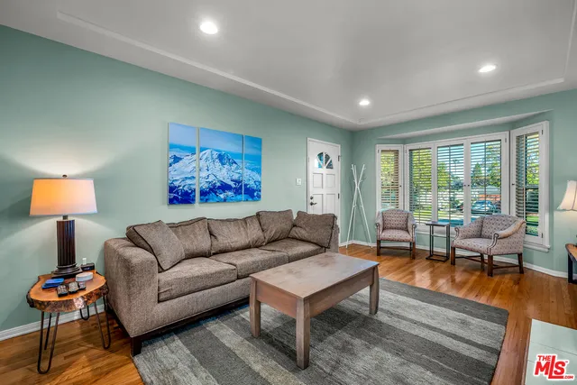 a living room with furniture a lamp and a table