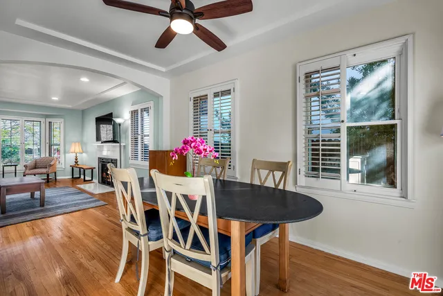 a dining room with furniture and wooden floor
