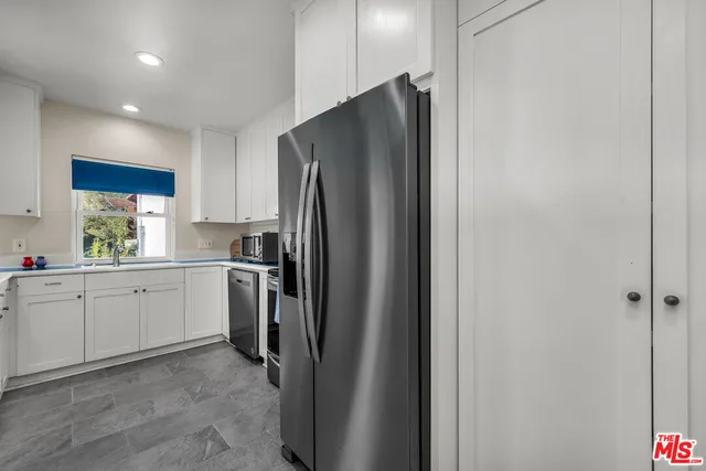 a kitchen with a refrigerator and a sink