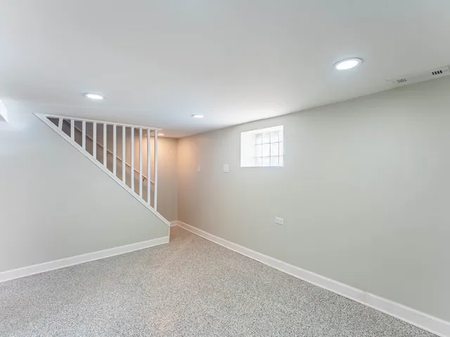 a view of an empty room with stairs