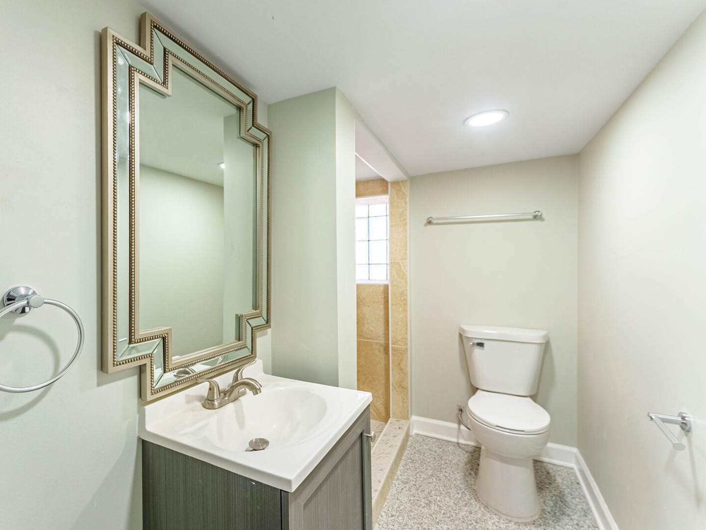 4025 West 56th Street Chicago, IL 60629 - Photo 17 of 26 a bathroom with a toilet sink and mirror