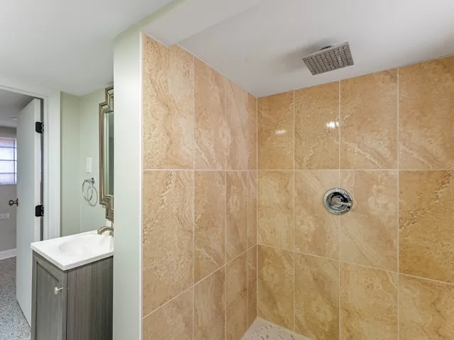 a bathroom with a shower and a sink