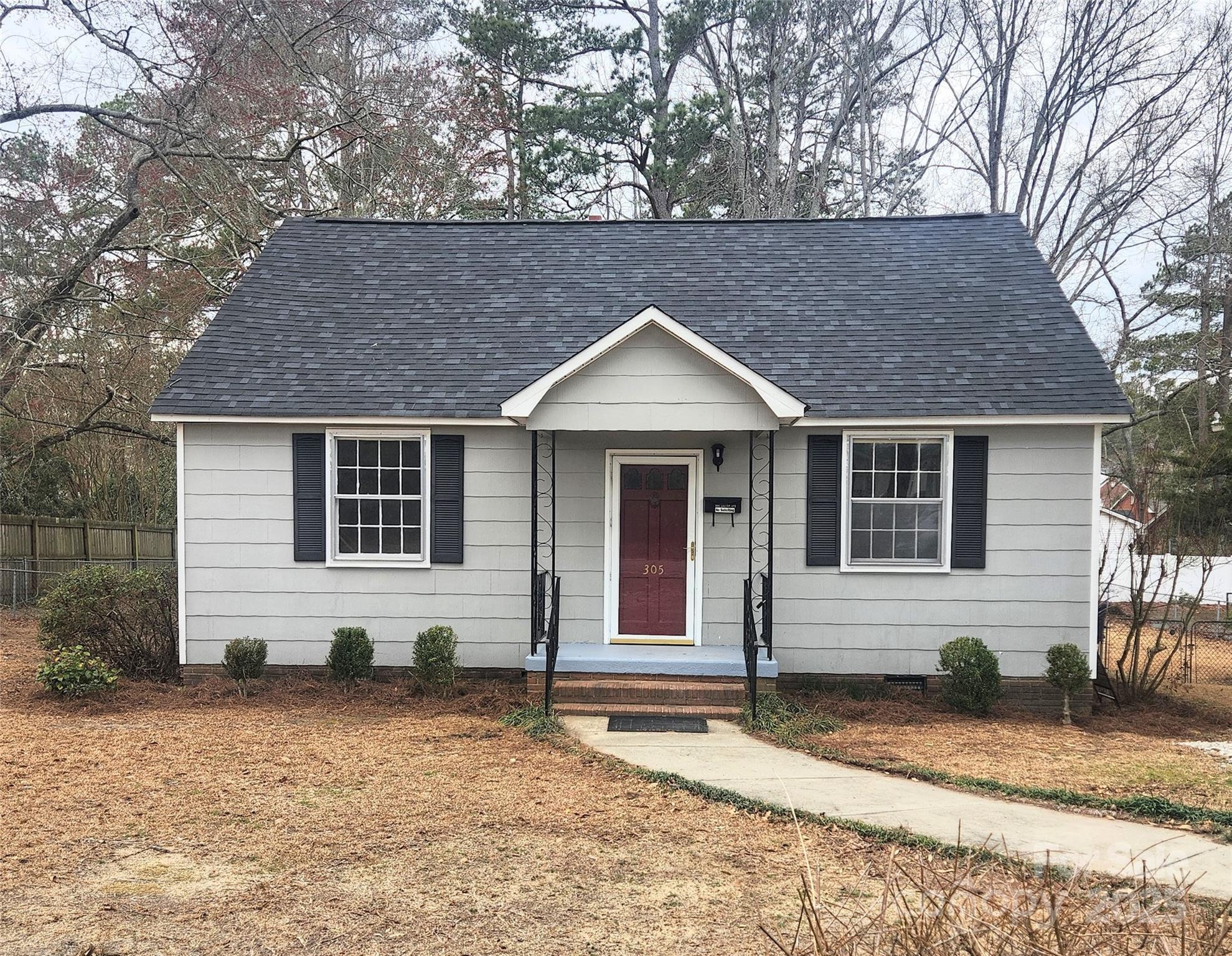 305 Louise Avenue Rockingham, NC 28379 - Photo 1 of 20 a front view of a house with a yard