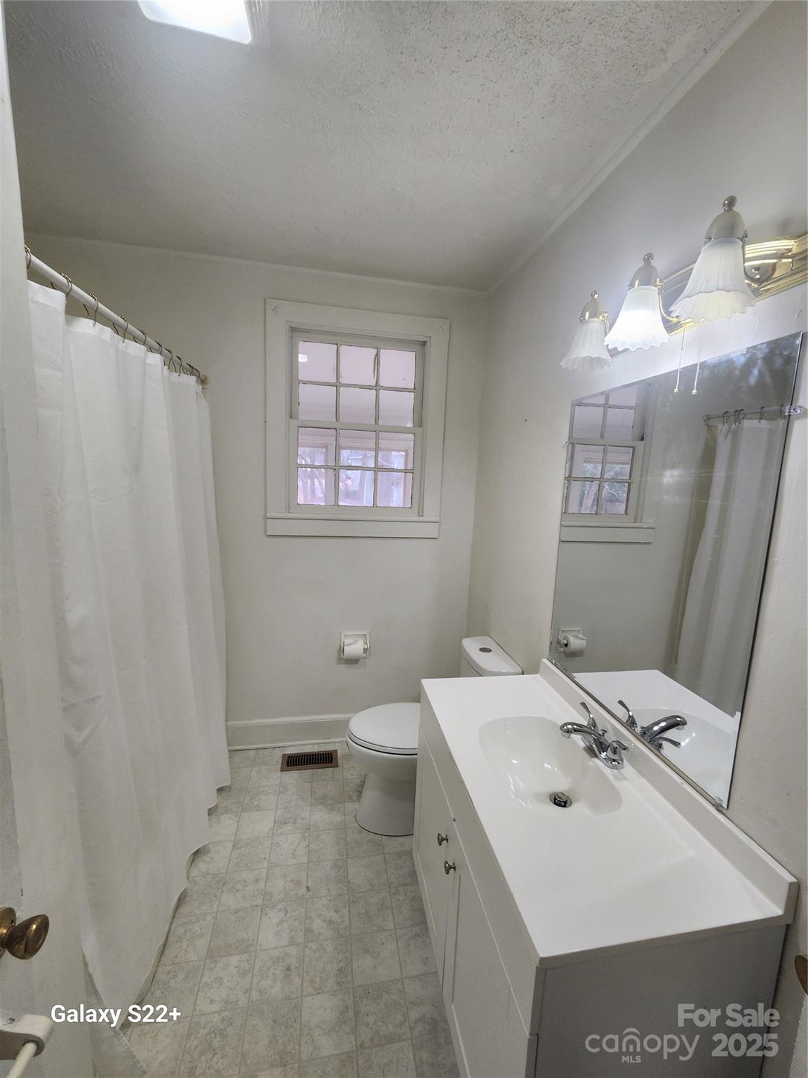 305 Louise Avenue Rockingham, NC 28379 - Photo 11 of 20 a bathroom with a sink a toilet and mirror