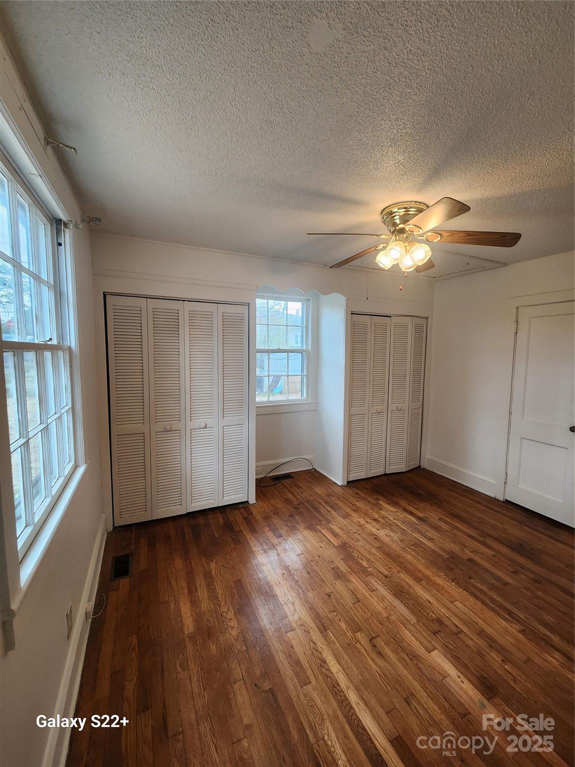 305 Louise Avenue Rockingham, NC 28379 - Photo 13 of 20 wooden floor in an empty room with a window