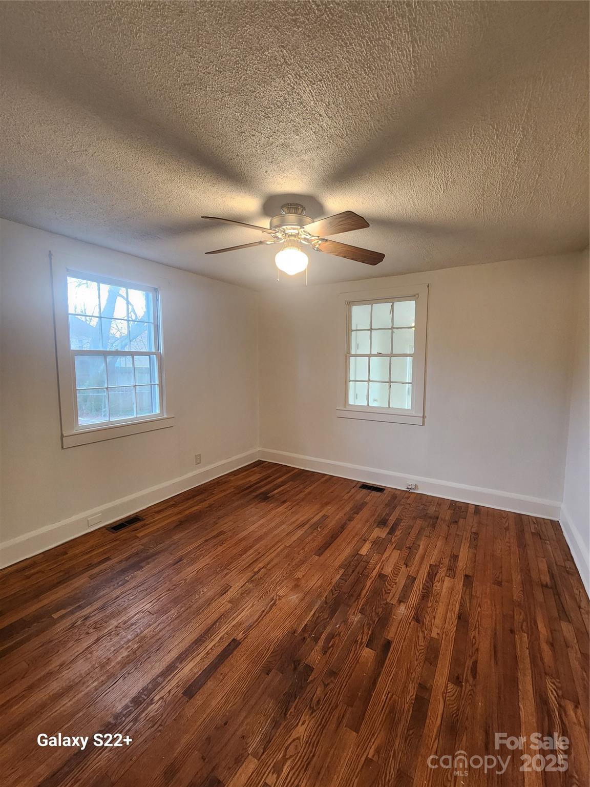 305 Louise Avenue Rockingham, NC 28379 - Photo 14 of 20 wooden floor in an empty room with a window
