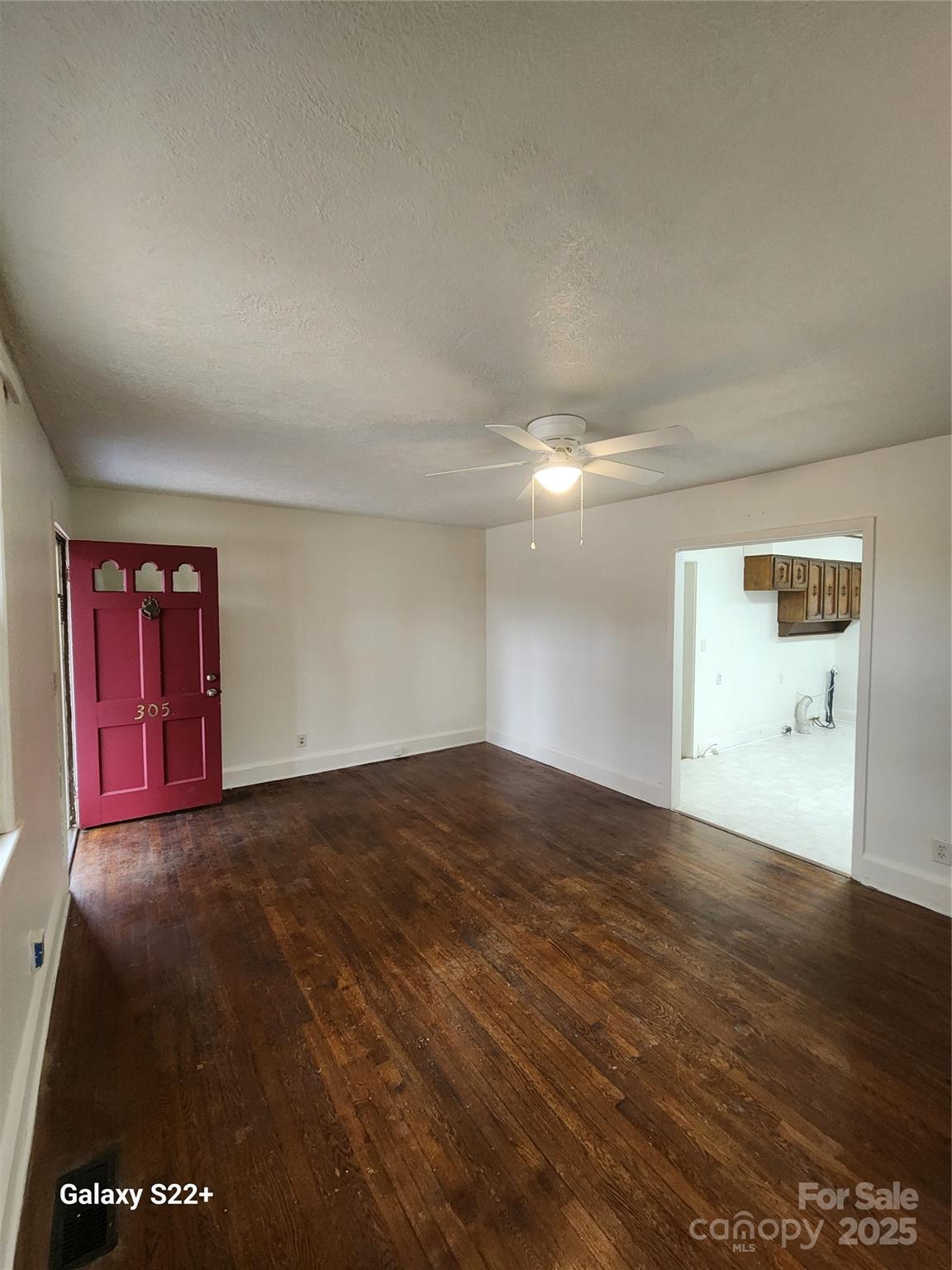 305 Louise Avenue Rockingham, NC 28379 - Photo 3 of 20 a view of empty room with wooden floor