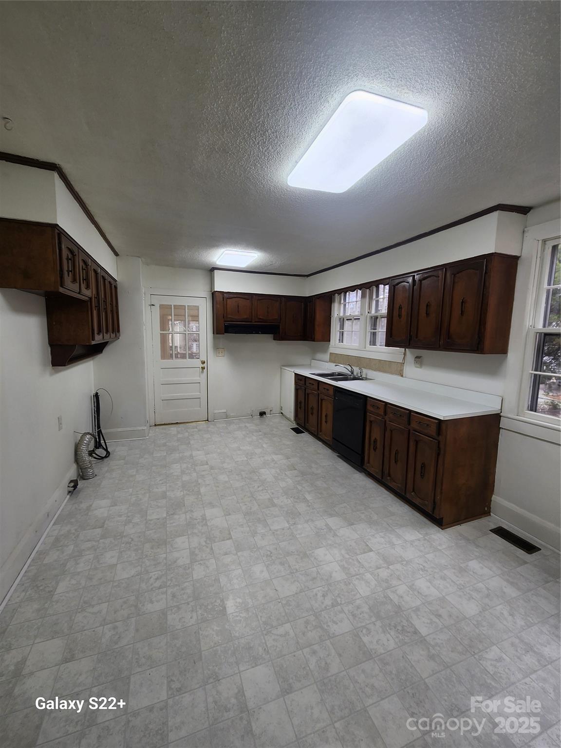 305 Louise Avenue Rockingham, NC 28379 - Photo 5 of 20 a large kitchen with stainless steel appliances a large counter top