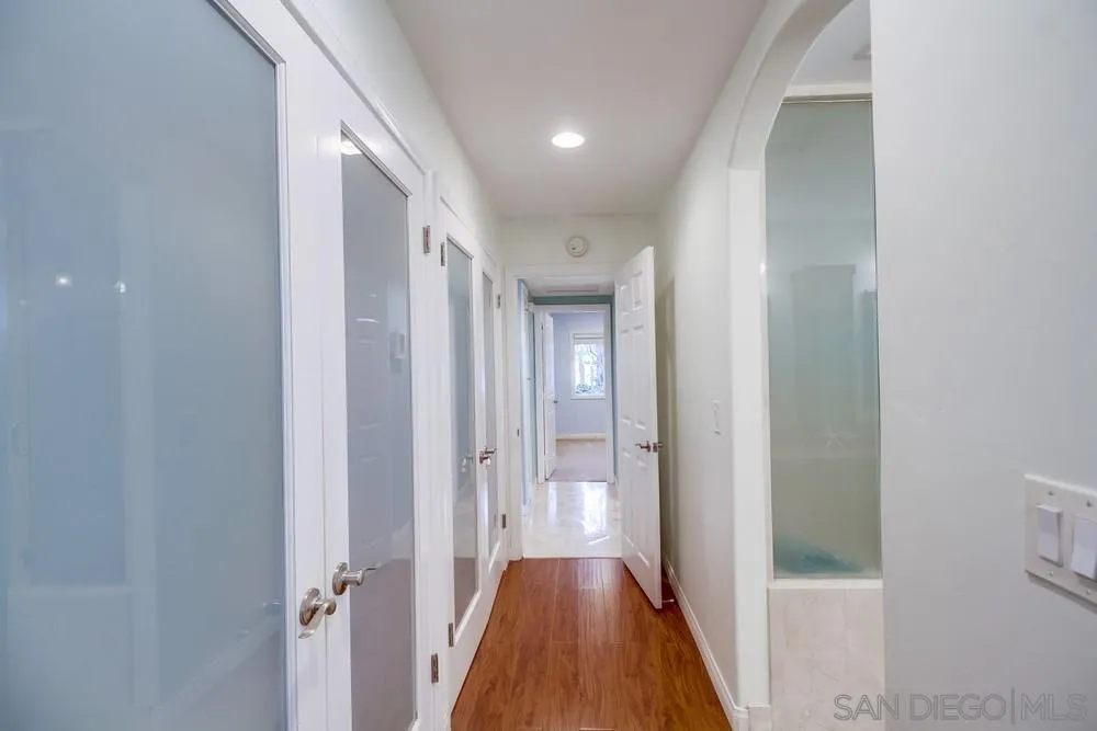 754 A Avenue Coronado, CA 92118 - Photo 18 of 25 a view of a hallway with wooden floor and a bathroom
