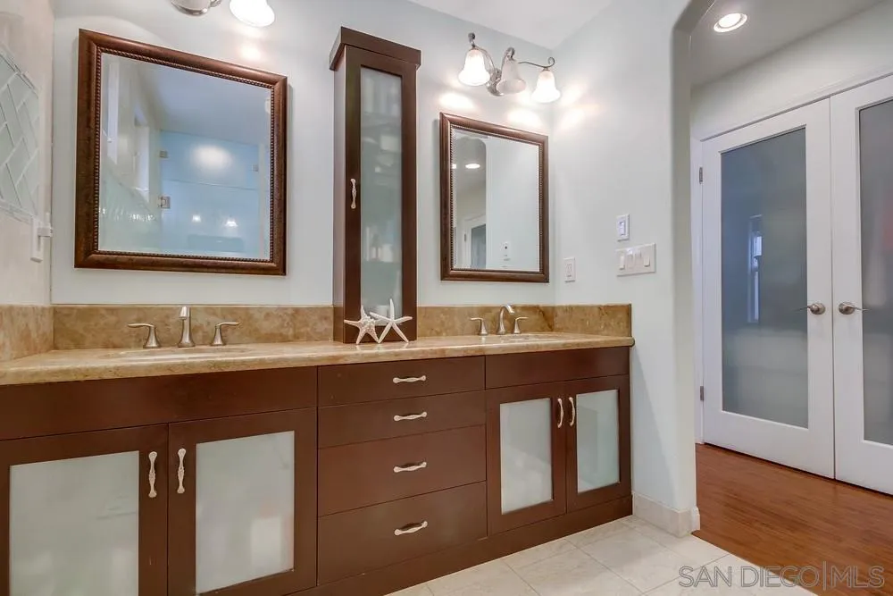 754 A Avenue Coronado, CA 92118 - Photo 19 of 25 a bathroom with a double vanity sink and a mirror