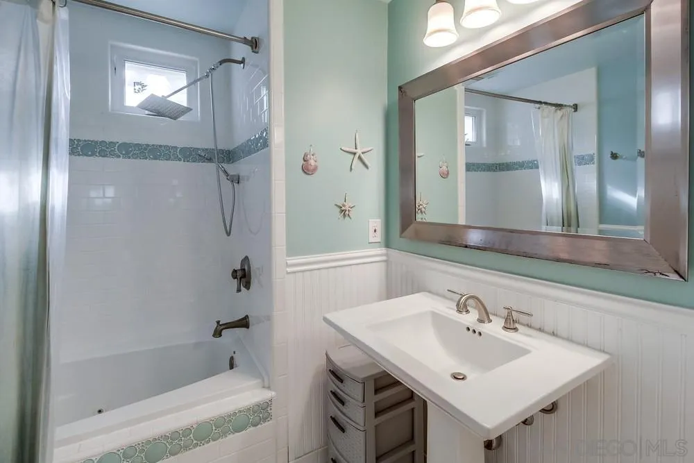 754 A Avenue Coronado, CA 92118 - Photo 22 of 25 a bathroom with a sink mirror and a bathtub