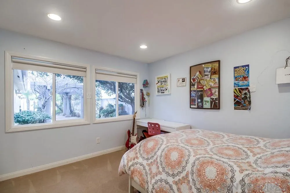 754 A Avenue Coronado, CA 92118 - Photo 23 of 25 a bedroom with a bed and a large window