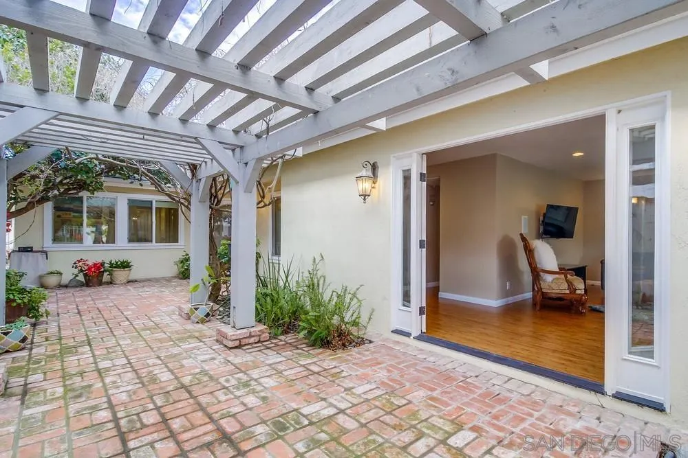 754 A Avenue Coronado, CA 92118 - Photo 5 of 25 a view of a porch with a table and chairs and potted plants