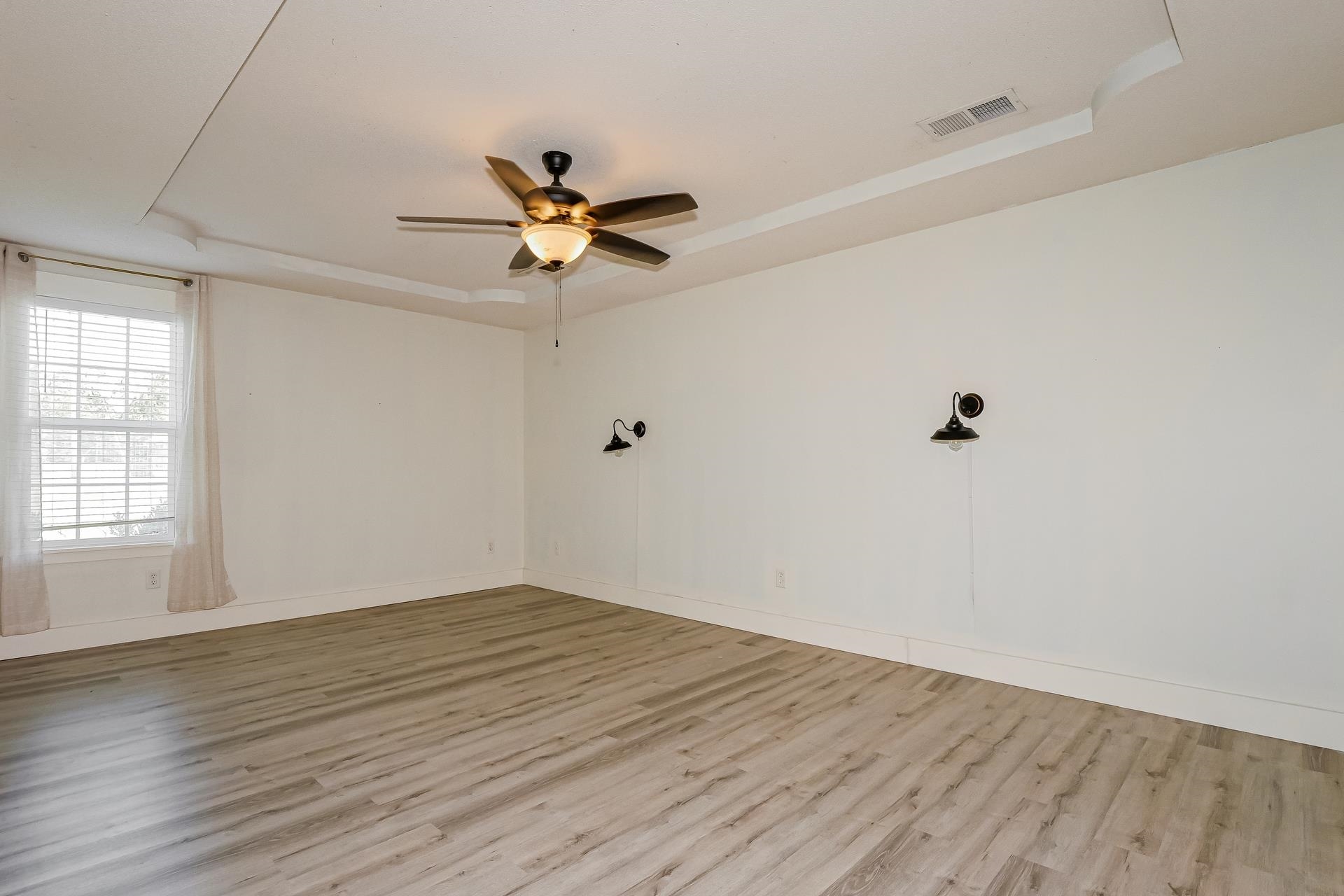 188 David Reed Drive Munford, TN 38058 - Photo 9 of 20 Spacious room featuring wood-finish flooring and a tray ceiling