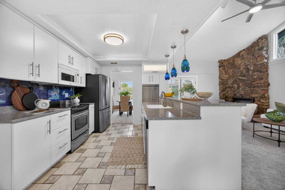 5033 El Cemonte Avenue Davis, CA 95618 - Photo 16 of 76 a kitchen with stainless steel appliances a refrigerator a sink a stove top oven a counter space and cabinets