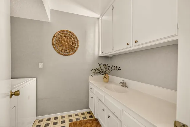 a bathroom with a double vanity sink mirror and toilet