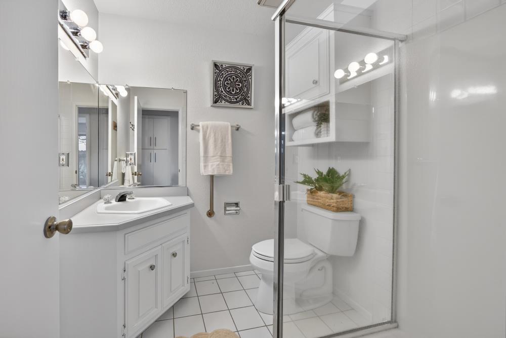 5033 El Cemonte Avenue Davis, CA 95618 - Photo 44 of 76 a spacious bathroom with a granite countertop sink a toilet and shower