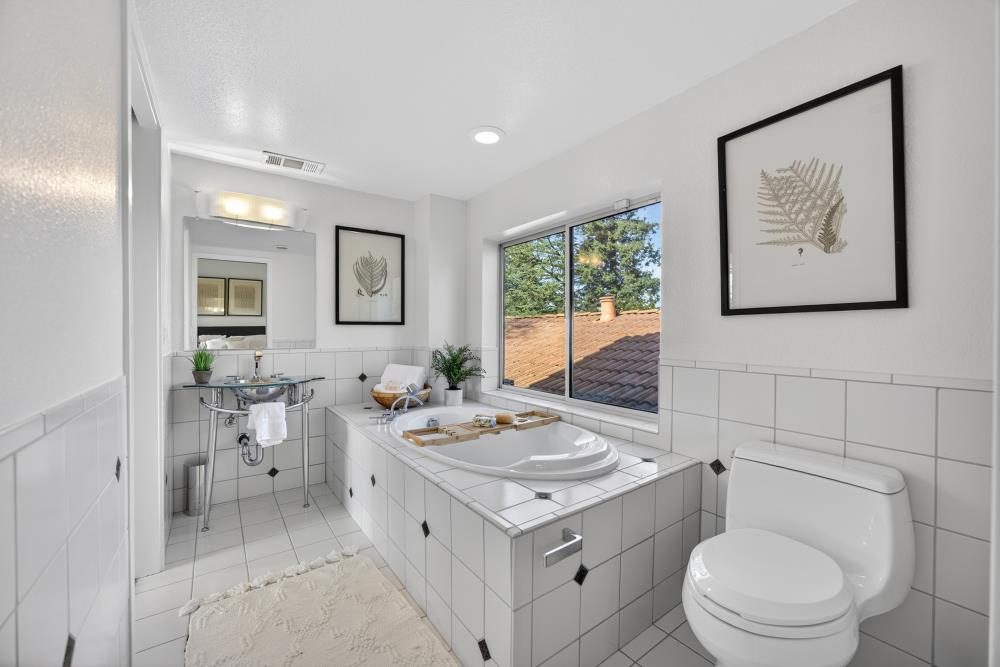 5033 El Cemonte Avenue Davis, CA 95618 - Photo 57 of 76 a bathroom with a toilet a sink and mirror