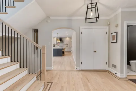a kitchen with granite countertop a sink cabinets stainless steel appliances and a window