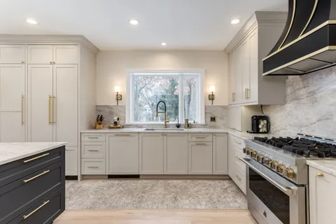 a kitchen with a sink and a stove top oven