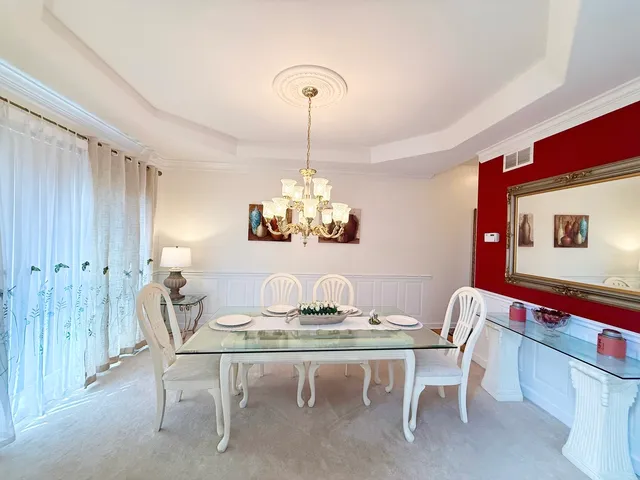 a kitchen with a refrigerator and white cabinets