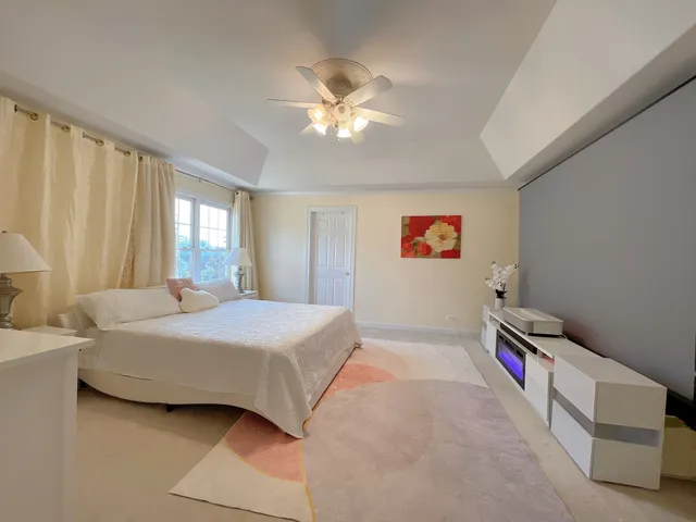 a large bathroom with a granite countertop sink a mirror and a bathtub