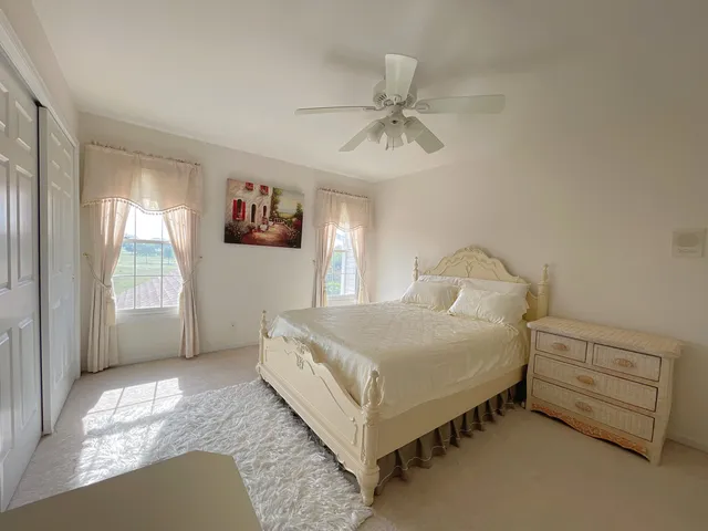 a bed room with a bed and a chair