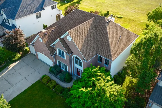 an aerial view of multiple houses with yard