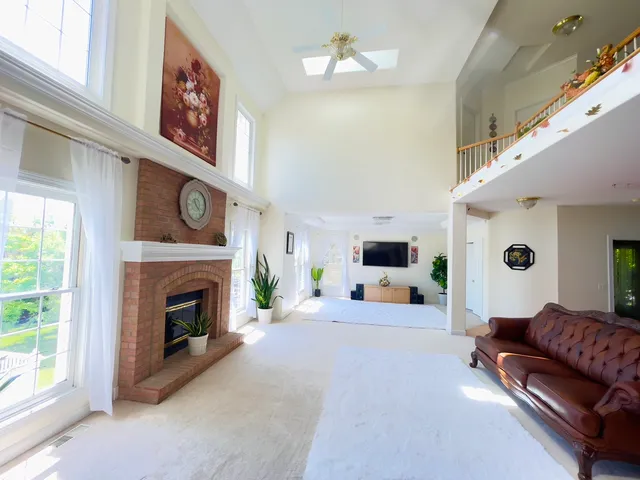 a living room with furniture and a fireplace with wooden floor