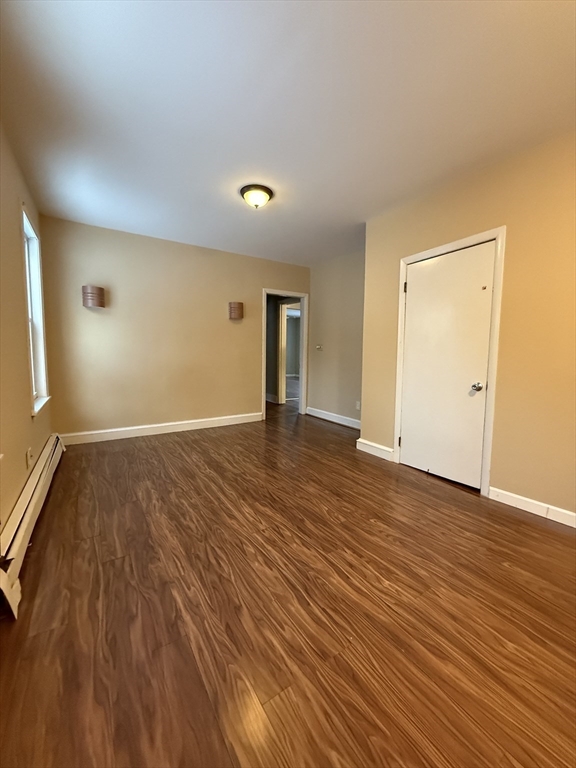 41 Holland Road, Unit 1 Worcester, MA 01603 - Photo 8 of 16 a view of an empty room with wooden floor and a window
