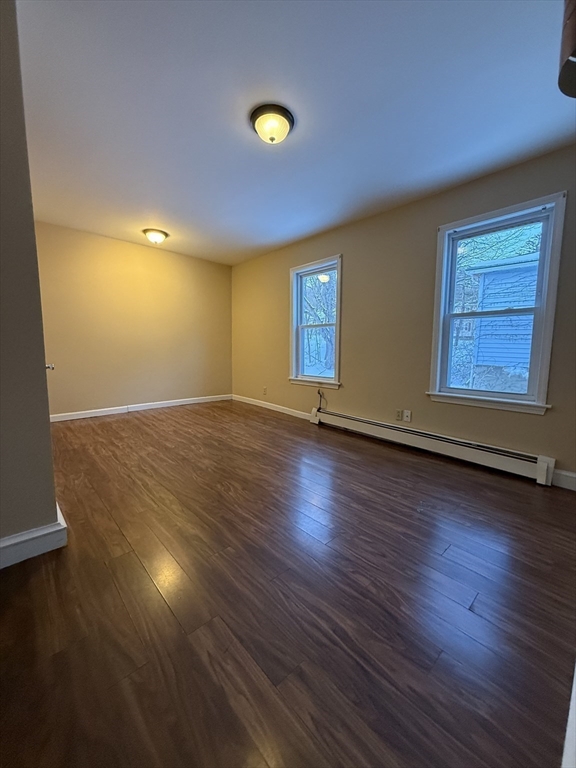 41 Holland Road, Unit 1 Worcester, MA 01603 - Photo 9 of 16 an empty room with wooden floor and windows