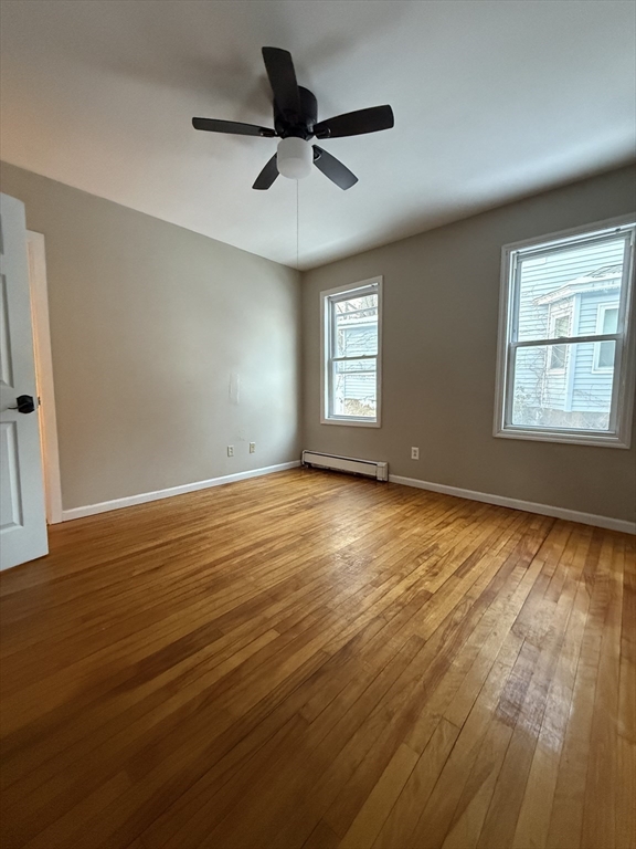 41 Holland Road, Unit 1 Worcester, MA 01603 - Photo 10 of 16 a view of an empty room with a window and wooden floor