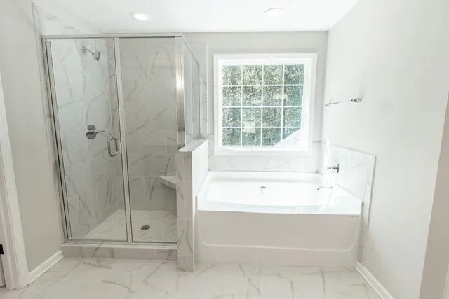 a bathroom with a shower and a bathtub